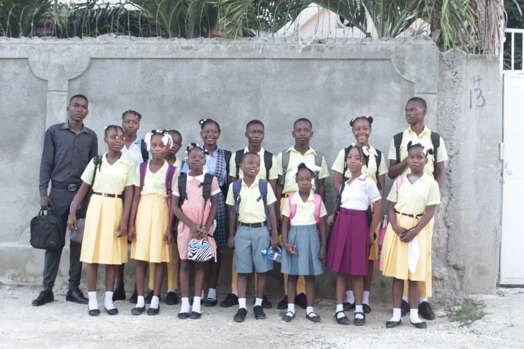 A group of children in school uniforms standing together