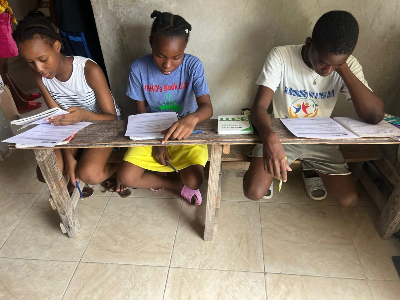 Children seated together working on their lessons